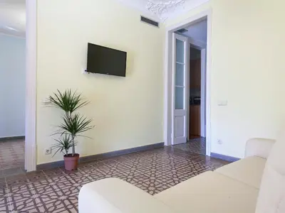 a living room with a couch and a tv on a wall at Apartment in Barcelona near Passeig de Gràcia in Barcelona