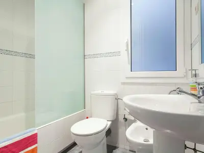 a white bathroom with a toilet and a sink at Apartment in Barcelona near Passeig de Gràcia in Barcelona