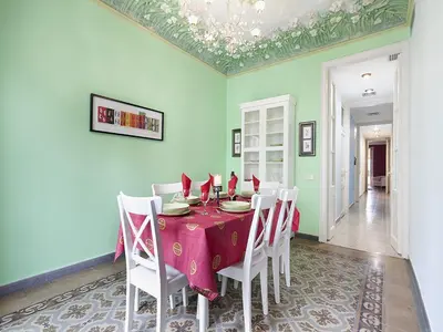 a dining room with a table and white chairs at Apartment in Barcelona near Passeig de Gràcia in Barcelona