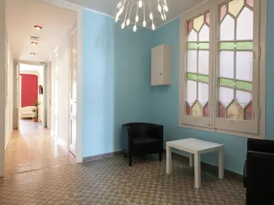 a living room with blue walls and a chair and a table at Apartment in Barcelona near Passeig de Gràcia in Barcelona