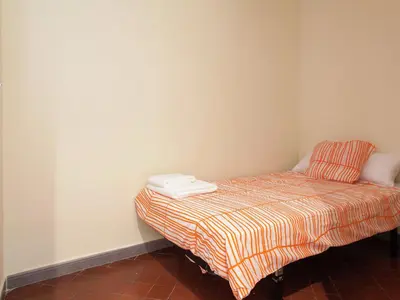 a bed sitting in a corner of a room at Apartment in Barcelona near Passeig de Gràcia in Barcelona