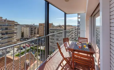 a balcony with a table and chairs on a balcony at Hola! - El Cortijo in Sitges