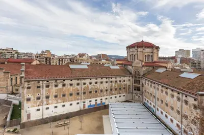 a view of an old building in a city at Enjoybcn Fira Apartment in Barcelona