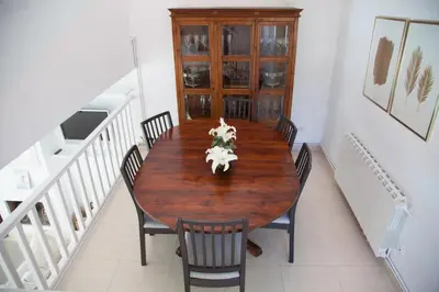 a wooden table in a room with chairs and a table at New Opening Villa Oasis Terramar in Sitges