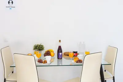 a dining room table with a plate of fruit and a bottle of wine at Key Sagrada Familia - Carrer Del Clot in Barcelona