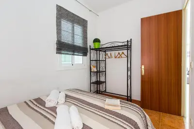 a bedroom with a bed with white towels on it at Key Sagrada Familia - Carrer Del Clot in Barcelona