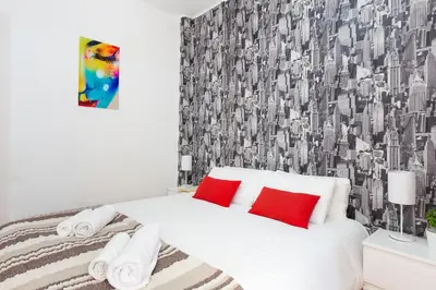a bedroom with a white bed with red pillows at Key Sagrada Familia - Carrer Del Clot in Barcelona