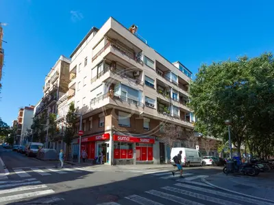 a building on the corner of a city street at Attic Terrace Montjuïc in Barcelona