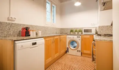 a kitchen with a washing machine and a dishwasher at You Stylish Boutique Apartments in Barcelona