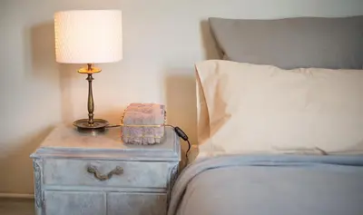 a lamp on a night stand next to a bed at You Stylish Boutique Apartments in Barcelona