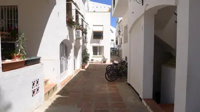 an alley with a bike parked in a building at Mini Apartamento Port Aiguadolç in Sitges