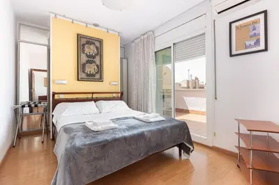 a bedroom with a bed with two towels on it at Rambla Cat · Penthouse with terrace in Barcelona