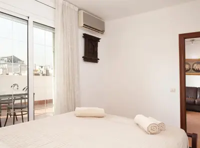 a bedroom with a bed and a large window at Rambla Cat · Penthouse with terrace in Barcelona
