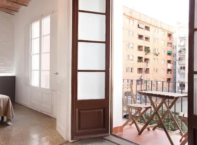 a room with a door and a table and a balcony at Napoles · Modernist flat close to Sagrada Familia in Barcelona