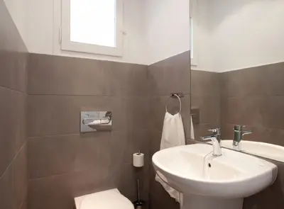 a bathroom with a sink and a toilet and a tub at Napoles · Modernist flat close to Sagrada Familia in Barcelona