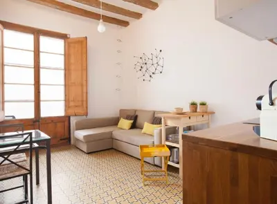 a living room with a couch and a table at Borrell · Near ramblas in Barcelona