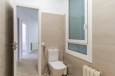 a bathroom with a toilet and a window at 2215 - AB Calabria Apartment in Barcelona