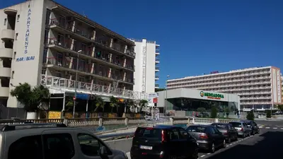 a group of cars parked in front of a building at Apartaments Mar Blau Calella in Calella