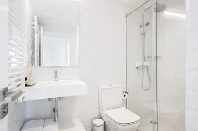 a bathroom with a toilet and a sink and a shower at Murmuri Residence Mercader in Barcelona
