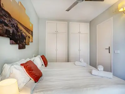 a bedroom with a large white bed with red pillows at Amazing Terrace in the Center by Hello Homes Sitges in Sitges