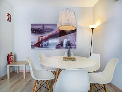 a dining room with a white table and chairs at Amazing Terrace in the Center by Hello Homes Sitges in Sitges