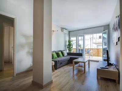 a living room with a couch and a table at Amazing Terrace in the Center by Hello Homes Sitges in Sitges