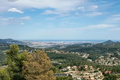 a view of a city from a mountain at Alcam Can Macia in Corbera de Llobregat