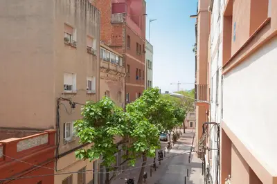 an alley with a tree in the middle of a building at Casa Natura Barcelona Fira & Camp Nou Stadium in Hospitalet de Llobregat