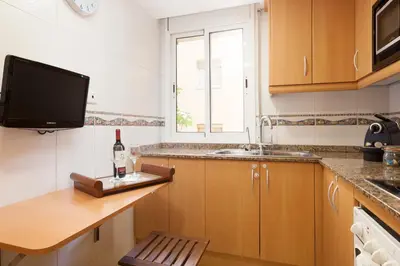 a kitchen with a bottle of wine on a counter at Casa Natura Barcelona Fira & Camp Nou Stadium in Hospitalet de Llobregat