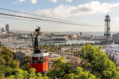 a red and white tram in a city at Casa Natura Barcelona Fira & Camp Nou Stadium in Hospitalet de Llobregat