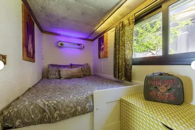 a small bedroom with a bed and a suitcase at Casa Miramiranda in Teià
