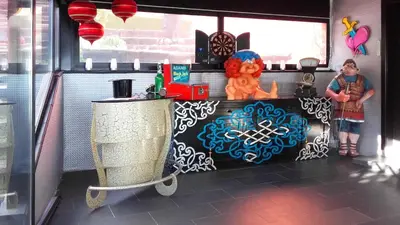 a boy standing at a counter in a food truck at Casa Miramiranda in Teià