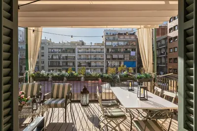 a balcony with a table and chairs and a city at HoHomes - Luxury Palacete in Barcelona
