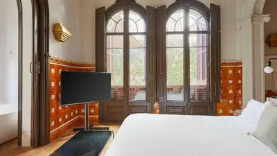 a bedroom with a bed and a flat screen tv at Le Palacete by Sweett in Barcelona