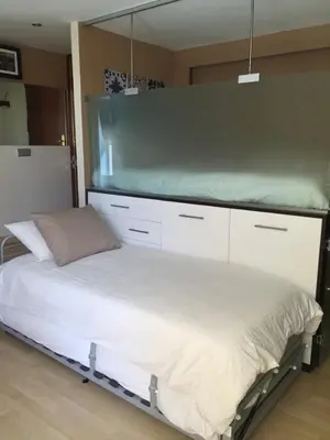 a bed in a room with a large mirror at Sitges Studio in Sitges