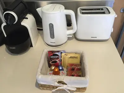 a basket of food sitting on a counter next to a coffee maker at Sitges Studio in Sitges