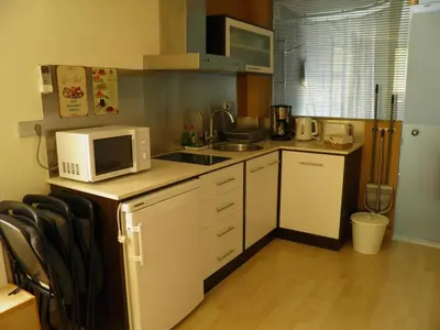 a small kitchen with a microwave and a stove at Sitges Studio in Sitges