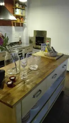 a kitchen counter with two wine glasses on it at El Terral in Sant Vicenç de Montalt