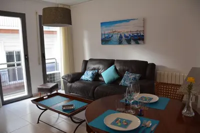 a living room with a couch and a table at Apartamento Flavia I Espalter in Sitges