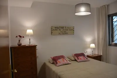 a bedroom with a bed and a dresser with two pillows at Apartamento Flavia I Espalter in Sitges