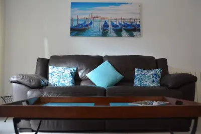 a living room with a brown couch and a coffee table at Apartamento Flavia I Espalter in Sitges