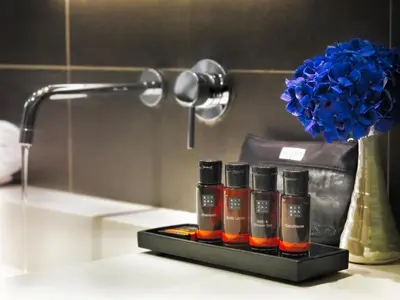 a group of four bottles of essential oils on a bathroom counter at H10 Casa Mimosa 4* Sup in Barcelona