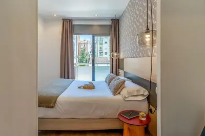 a bedroom with a large bed with a window at AB Sagrada Familia - Gaudí in Barcelona