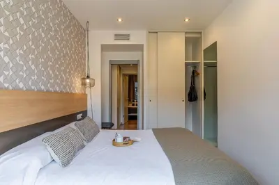 a bedroom with a large white bed with a tray on it at AB Sagrada Familia - Gaudí in Barcelona