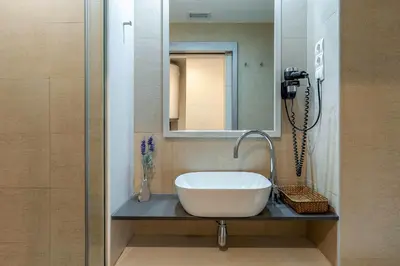 a bathroom with a sink and a mirror at AB Sagrada Familia - Gaudí in Barcelona