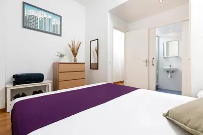a white bedroom with a large bed and a sink at Mayerling Schumann Barcelona in Barcelona