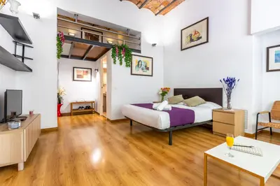 a bedroom with a bed and a living room at Mayerling Schumann Barcelona in Barcelona