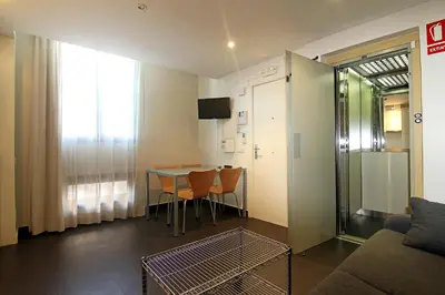 a living room with a table and chairs and a couch at Classbedroom Born Apartments in Barcelona
