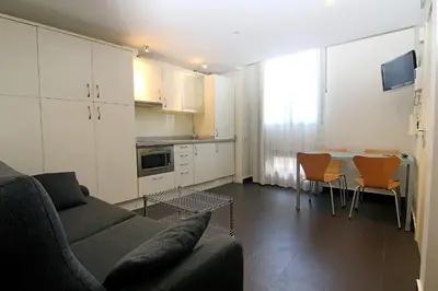 a living room with a couch and a table at Classbedroom Born Apartments in Barcelona