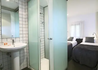 a bathroom with a sink and a bedroom at Classbedroom Born Apartments in Barcelona